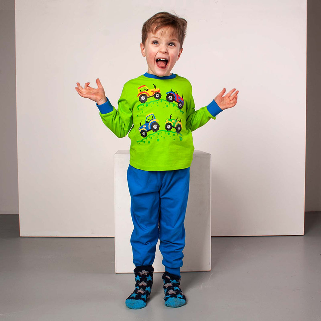 Boy wearing green and blue long length tractor pyjamas
