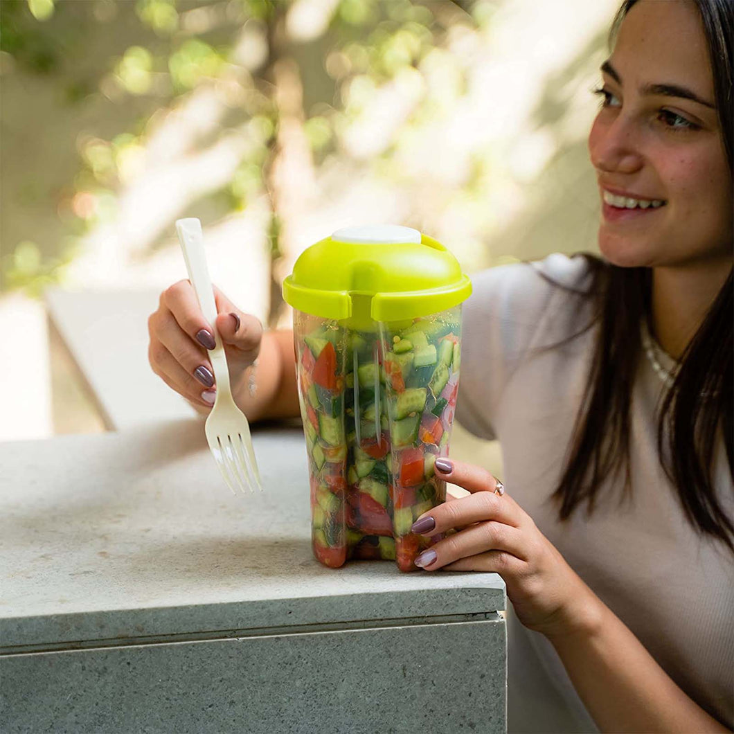 Woman holding a filled 'My Salad Box' and reusable fork