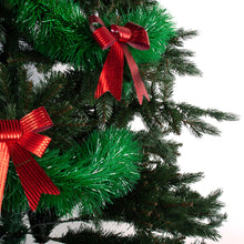 Load image into Gallery viewer, Shiny green tinsel wrapped around a tree decorated with red bows
