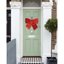 Load image into Gallery viewer, Velvet door bow hung on a front door
