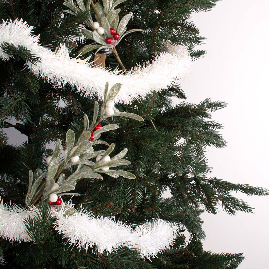 White fine cut tinsel wrapped around a tree decorated with picks